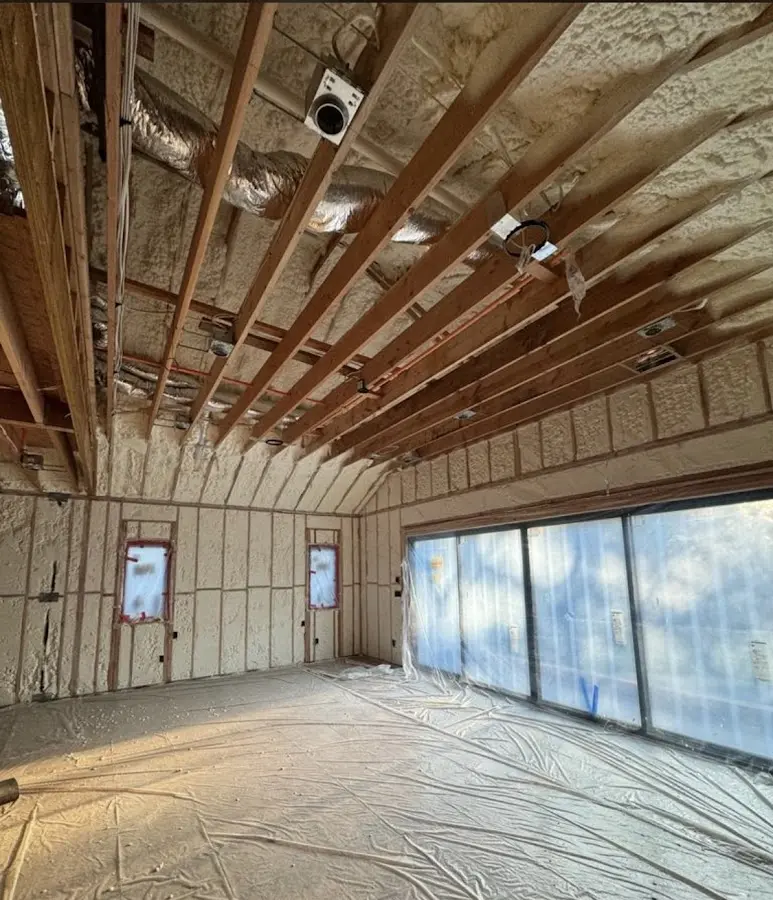 Interior walls and ceiling insulated with spray foam during new construction in Troy
